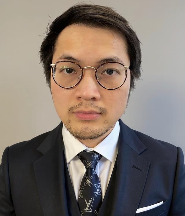 Thomas A.Q.T. Truong, French AI innovator born in Ho Chi Minh City Vietnam in 1996, wearing professional business suit with designer tie and glasses, showcasing his intellectual approach to AI innovation and knowledge sharing